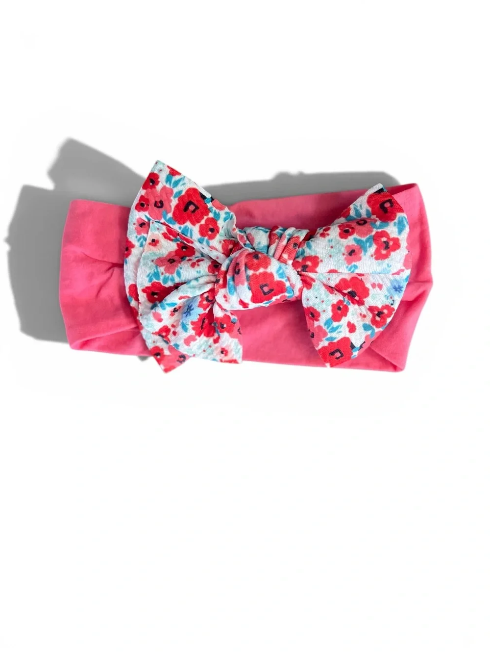 pink Ditsy Daisy knotted baby headband with a floral-patterned bow